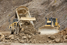 Heavy Articulated Dump Truck Work At A Huge Dam Construction Site