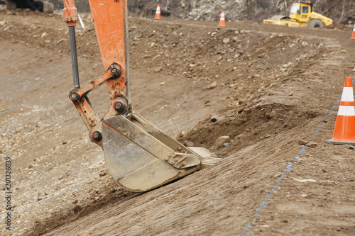 Cuadros en Lienzo Construction site: Backhoe making banked slope