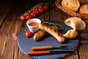 Wall Mural - rustic bratwurst with ketchup and fresh rolls