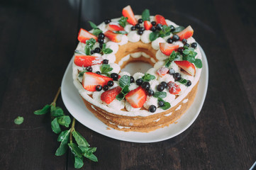 beautiful almond cake with fruit. strawberry, blueberry, mint