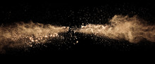 Abstract Colored Brown Powder Explosion Isolated On Black Background.