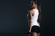 © LIGHTFIELD STUDIOS - beautiful female bodybuilder posing in sportswear, isolated on grey