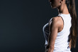 © LIGHTFIELD STUDIOS - cropped view of muscular sportswoman posing in sportswear, isolated on grey