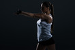 © LIGHTFIELD STUDIOS - attractive strong female bodybuilder stretching arms, isolated on black