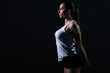 © LIGHTFIELD STUDIOS - beautiful athletic sportswoman stretching arms, isolated on black