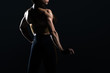 © LIGHTFIELD STUDIOS - female bodybuilder posing and showing muscles, isolated on black