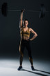 © LIGHTFIELD STUDIOS - young strong bodybuilder holding barbell, on black