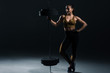 © LIGHTFIELD STUDIOS - young attractive bodybuilder posing with big barbell, on black