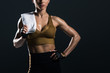 © LIGHTFIELD STUDIOS - cropped view of sweaty female bodybuilder with towel, isolated on grey