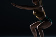 © LIGHTFIELD STUDIOS - cropped view of muscular bodybuilder doing squats, isolated on black