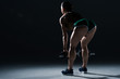 © LIGHTFIELD STUDIOS - back view of sexy female bodybuilder lifting dumbbells, on black