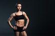 © LIGHTFIELD STUDIOS - beautiful sexy female bodybuilder posing in black sportswear,  isolated on grey