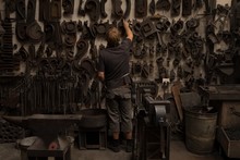 Blacksmith Looking At Metal Equipments