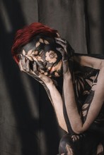 Portrait Of A Sad Woman In Black And Gold Body Paint