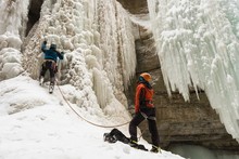 Rock Climbers Climbing Rocky Mountain During Winter