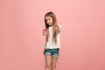 Doubtful pensive teen girl rejecting something against pink background