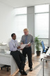 © DragonImages - Discussing business document