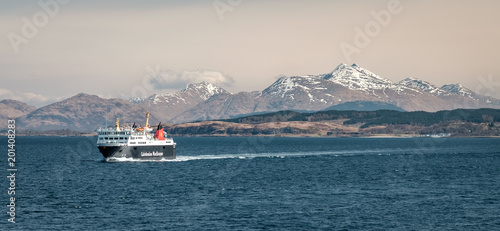 Cuadros en Lienzo Ferry sailing between Oban and the Isle of Mull with snow capped highland peaks