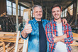 © Karanov images - Carpenters standing proud in front of a workshop, family business