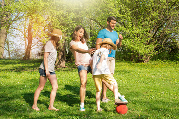 Wall Mural - Fun in the Park family playing football