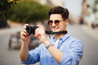 © F8  \ Suport Ukraine - Portrait of happy young man, tourists with camera in the new city.