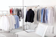 © New Africa - Dry-cleaner's interior with clothes on racks