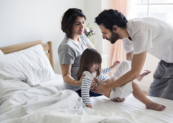 Wall Mural - Family with a pregnant mother spending time together