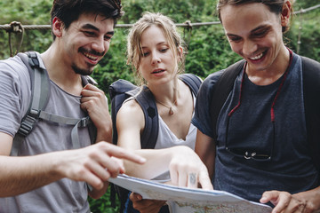 Wall Mural - Friends finding their way with a map