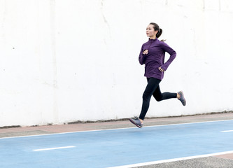 Wall Mural - White woman running on track