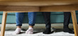 © Rawpixel.com - Feet sticking out under a sofa table