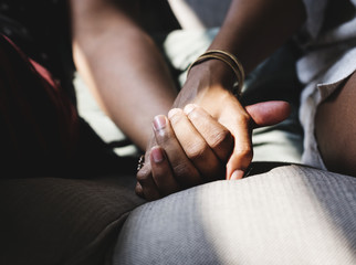 Closeup of couple holding hands