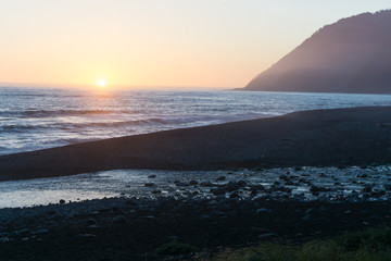 Wall Mural - A colorful beach sunset over the black sands of the Lost Coast backpacking trail in California