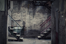 Dark Empty Yard With Two Staircases And A Hanging Loop. A Place For Suicide. The Theme Of Suicide.