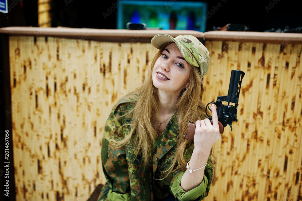 Military Girl In Camouflage Uniform With Revolver Gun At Hand Against 