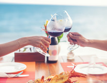 A Romantic Dinner In Summer On A Beach At Sunset With Two Glasses Of Wine