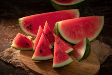 Watermelon And Watermelon Pieces In A Wooden Background