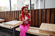 © AS Photo Family - Fashionable african american girl at pink pants and red dreads posed outdoor with mobile phone.