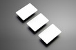 © olegphotor - Stylish mockup of a three bank (gift) cards placed diagonally on a gray background.