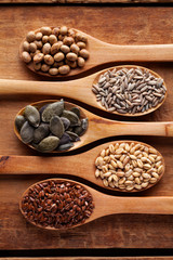 Wall Mural - Grains, cereals and seed in wooden spoons. Oat, wheat, rye, secale, soya, Flax seed. Flat lay.