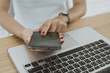 © pixindy - Woman hand with computer laptop on wood table.