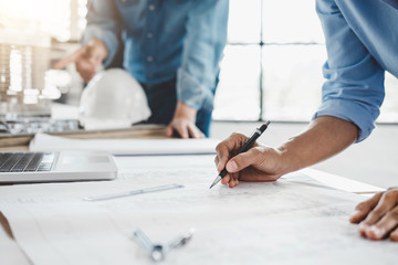 Wall Mural - hands of architect or engineer working on blueprint meeting for project working with partner on mode