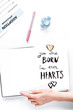 © 279photo - adopting baby form with notebook on table background top view