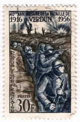 Leeds, England - April 20 2018: an old blue french postage stamp with an of world war one soldiers in trenches in the battle of verdun