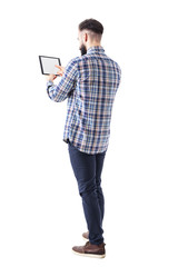 Rear side view of bearded business man pushing button on tablet computer blank touch screen. Full body isolated on white background. 