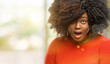 © Krakenimages.com - Beautiful african woman scared in shock, expressing panic and fear, outdoor