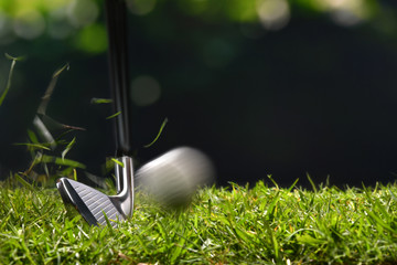 Wall Mural - Golfer hitting golf ball with club on beatuiful golf course