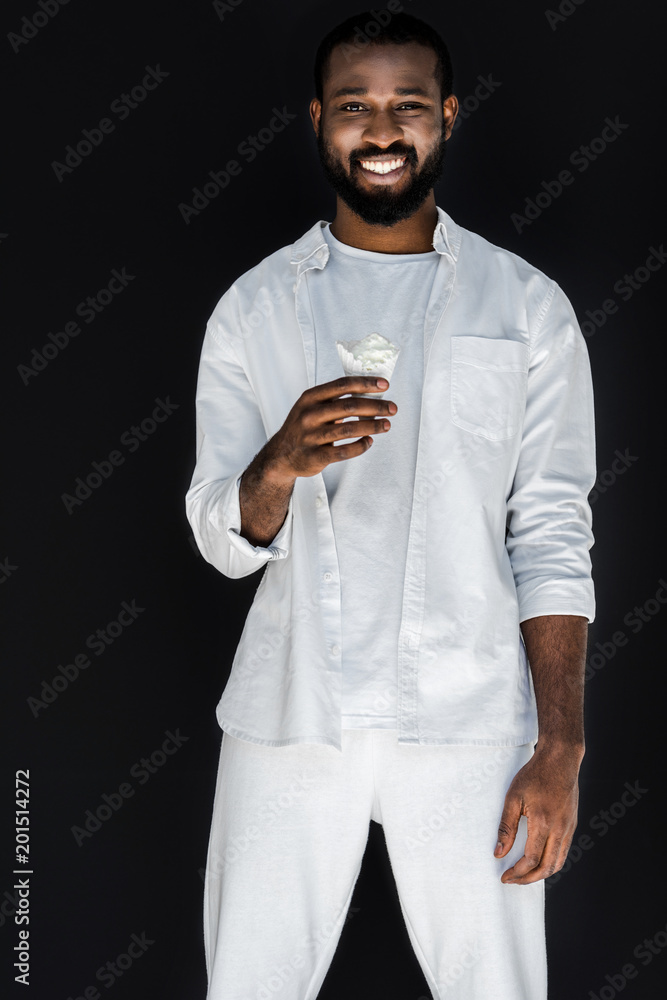 handsome stylish african american man in white clothes holding white ice cream cone isolated on black Stock Photo | Adobe Stock handsome stylish african american man in white clothes holding white ice cream cone isolated on black Stock Photo | Adobe Stock