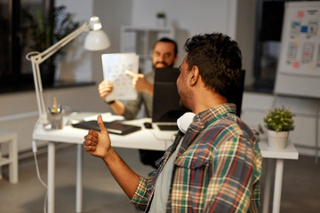 Sticker - business, deadline and web design people concept - happy creative man showing papers to colleague at night office