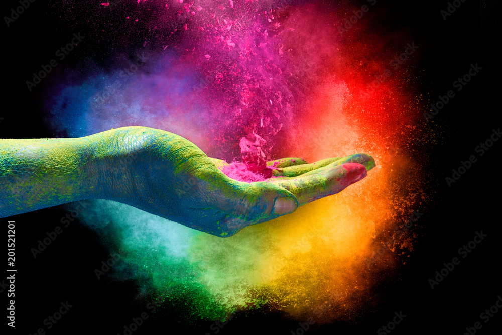 Magical rainbow colored dust exploding from a hand. Holi Festival - obrazy, fototapety, plakaty 