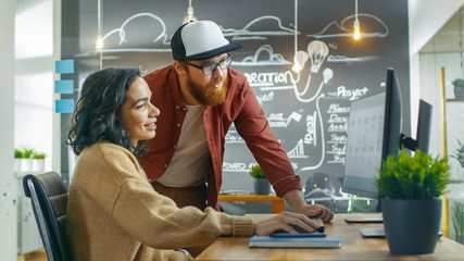 Wall Mural - at the desk beautiful woman developer talks with programer, together they design new mobile game/ ap
